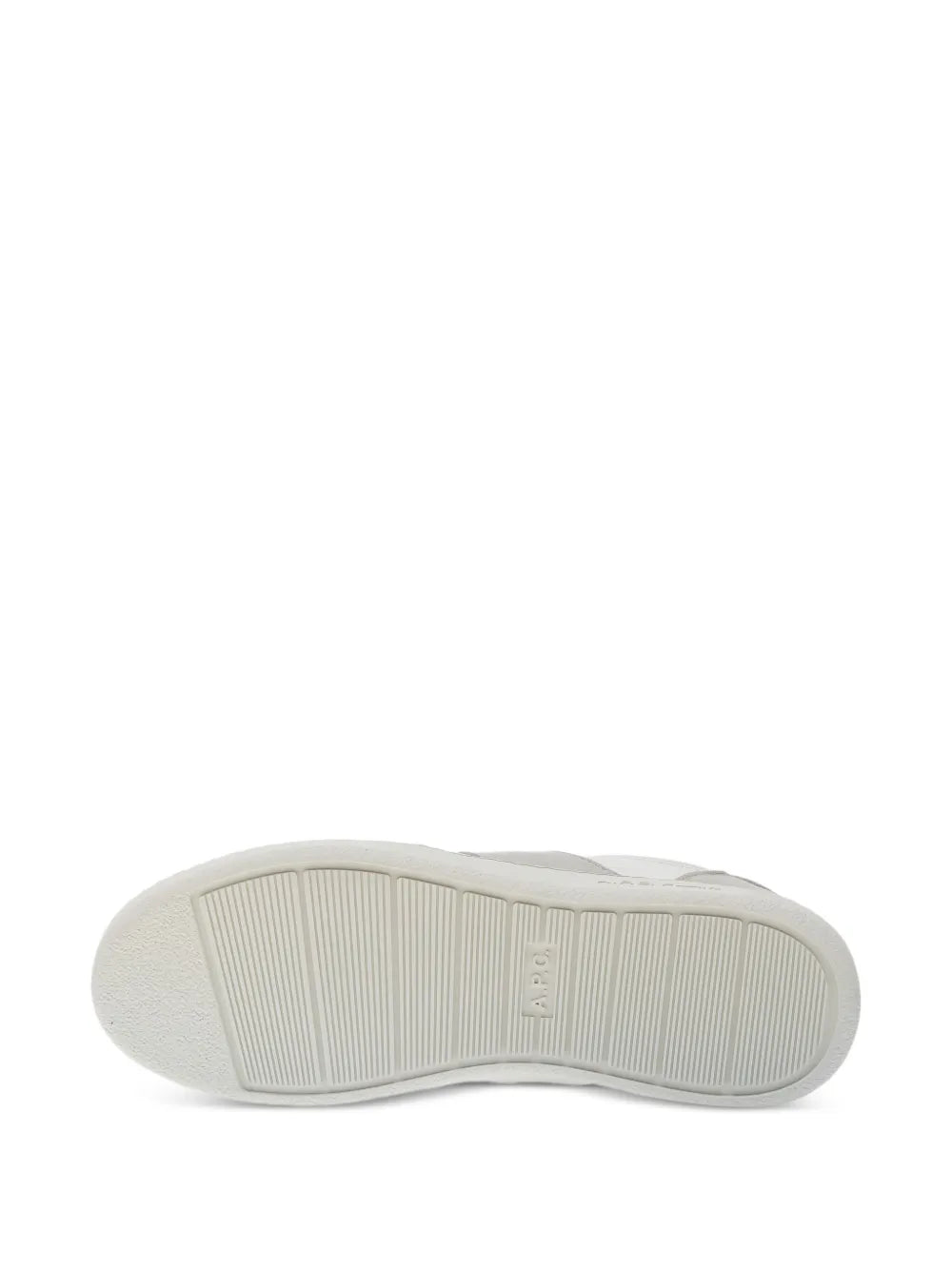 White rubber outsole of low-top sneakers with ribbed tread