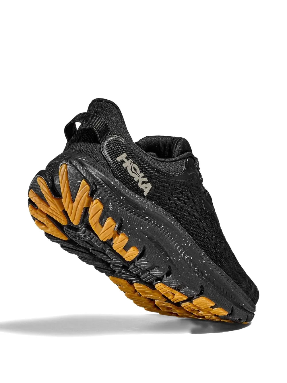 Hoka black sneakers with perforated upper and ribbed sole, showing yellow tread detail.