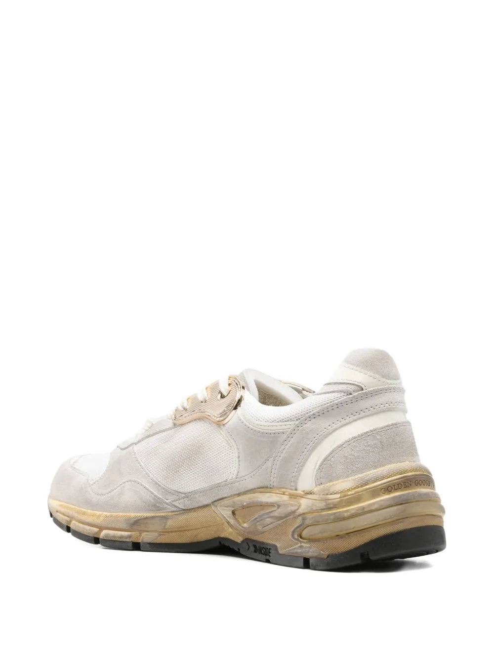 White dad sneakers with side stripe panels and worn gold-edged midsole