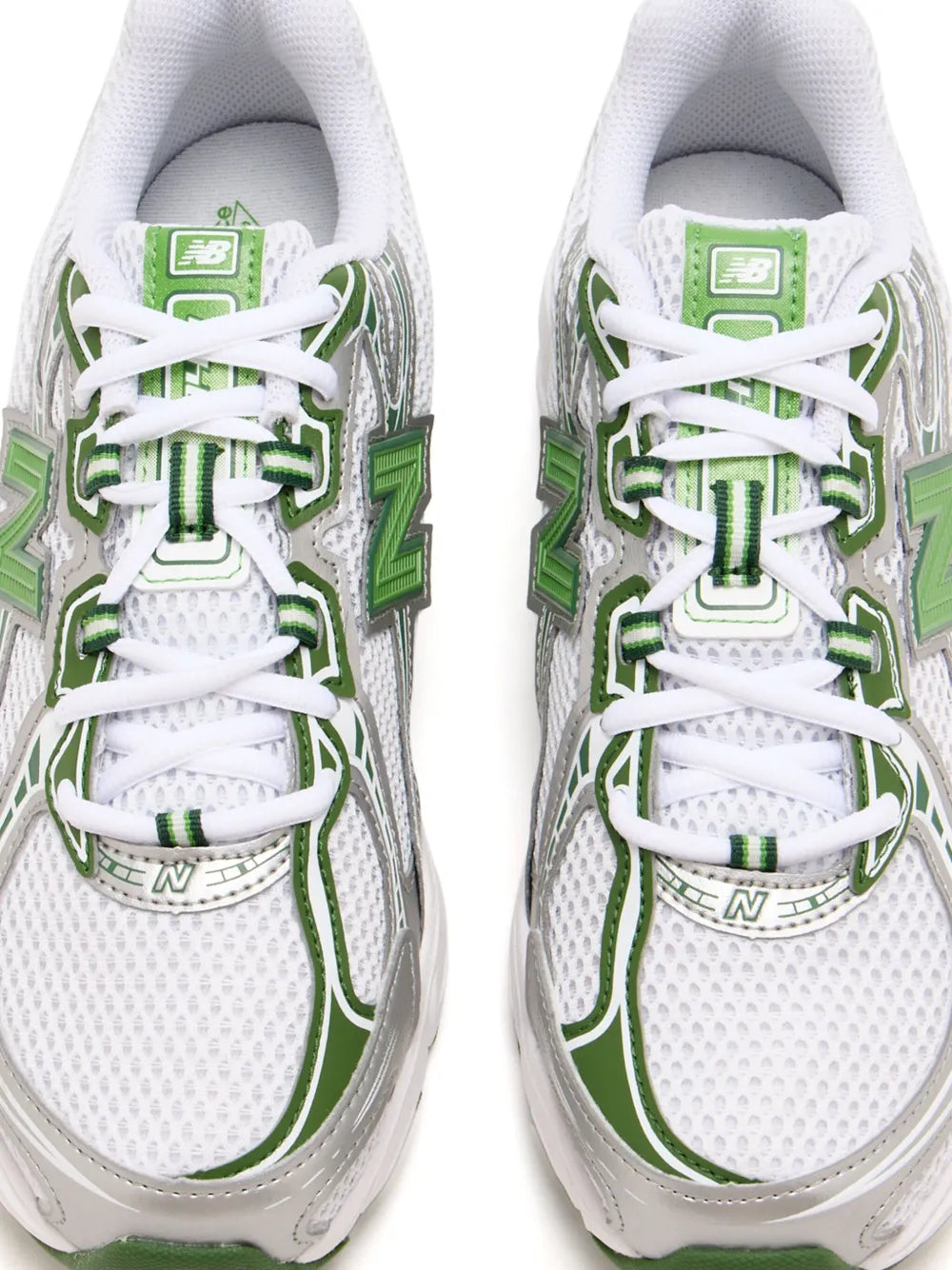New Balance 740 lace-up sneakers, white mesh uppers with green logo details.