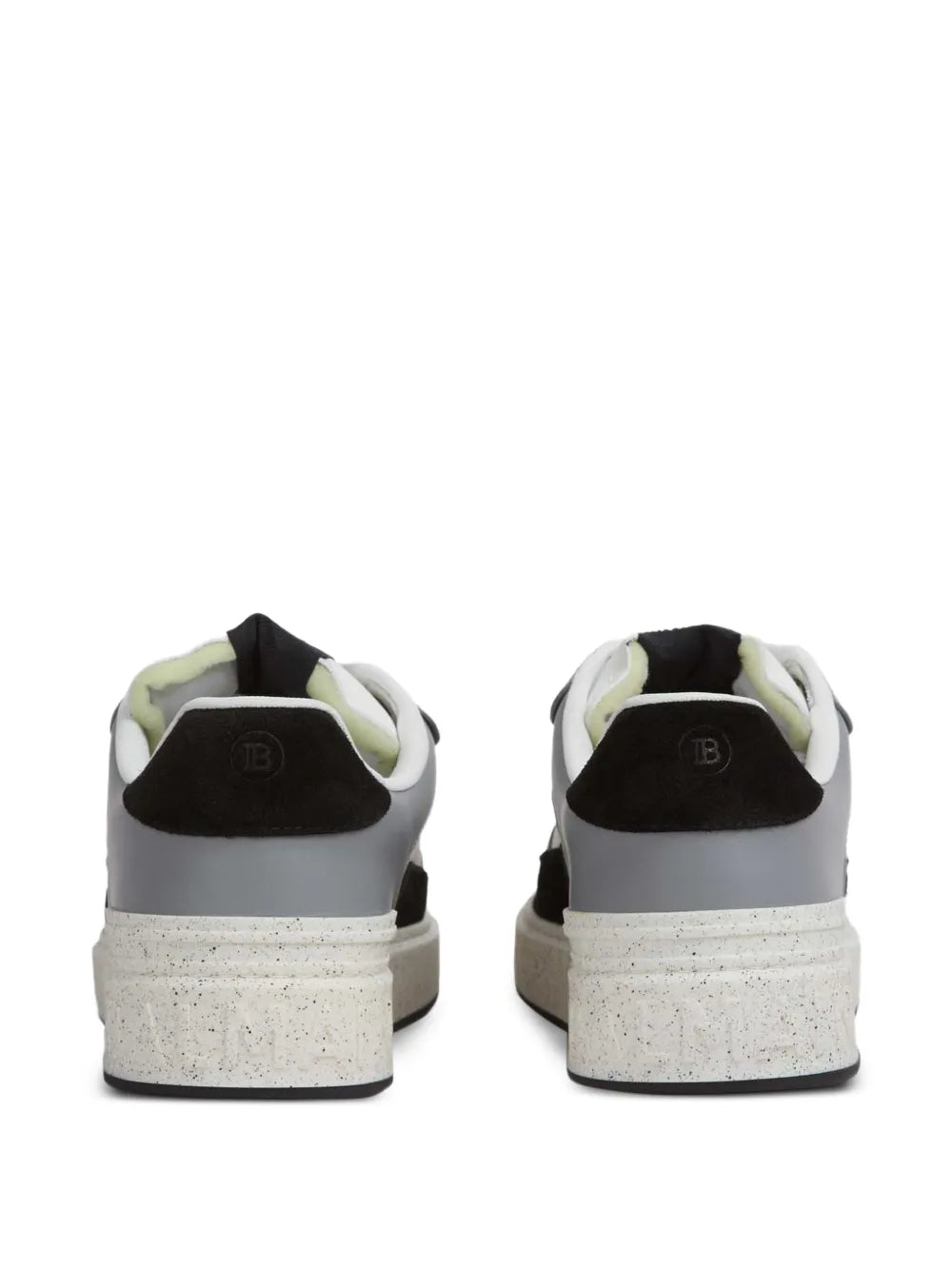 Back view of black and white leather sneakers with heel loop and speckled sole