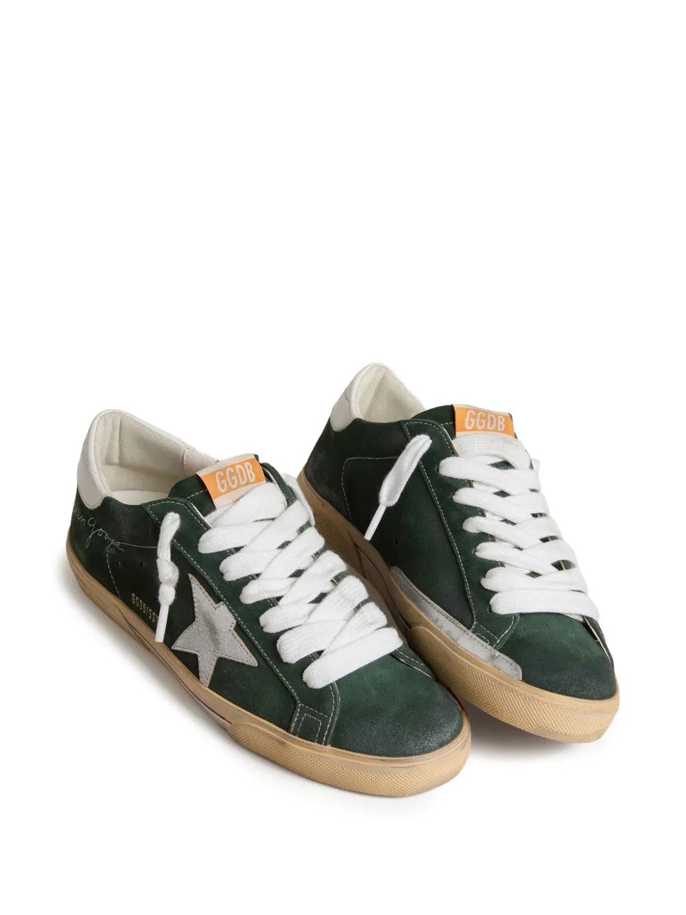 Green leather low-top sneakers, pair view, white laces, silver star and tan heel tab