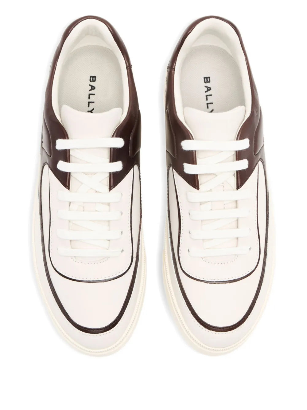 White leather sneakers with dark brown trim; front view of two lace-up shoes