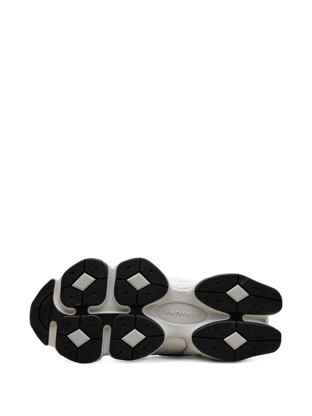 White rubber sneaker outsole with black traction pods and molded diamond grips