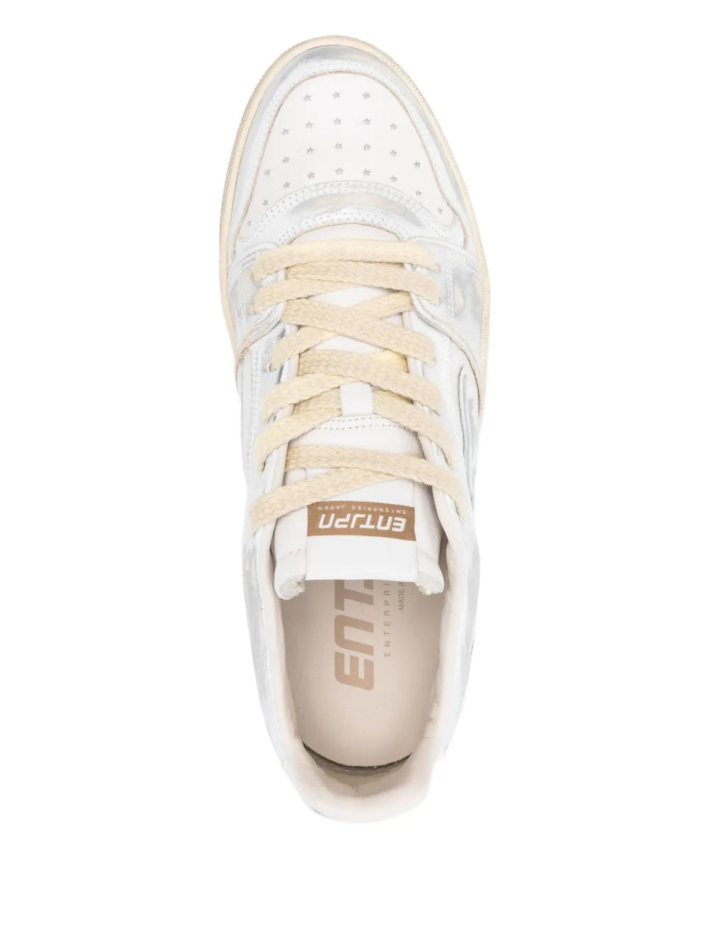 White low-top sneakers with lace-up front and logo patch at tongue