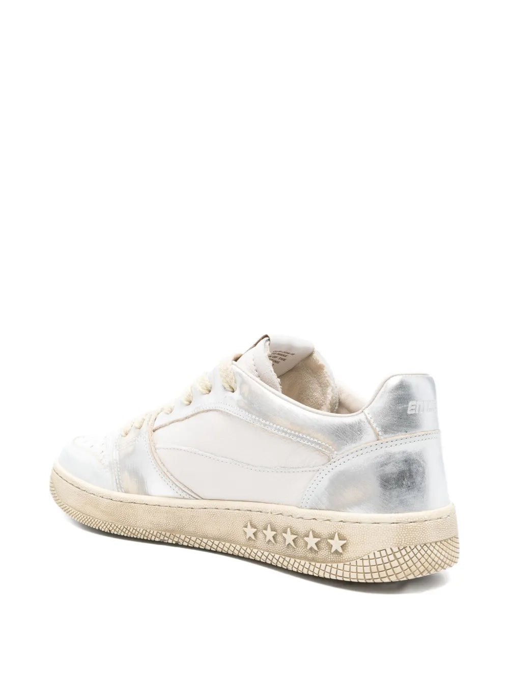 White low-top sneakers with star row detail on beige textured rubber sole