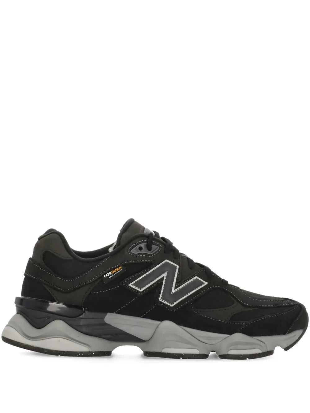 Black New Balance sneakers with side logo, lace-up upper, and chunky gray sole