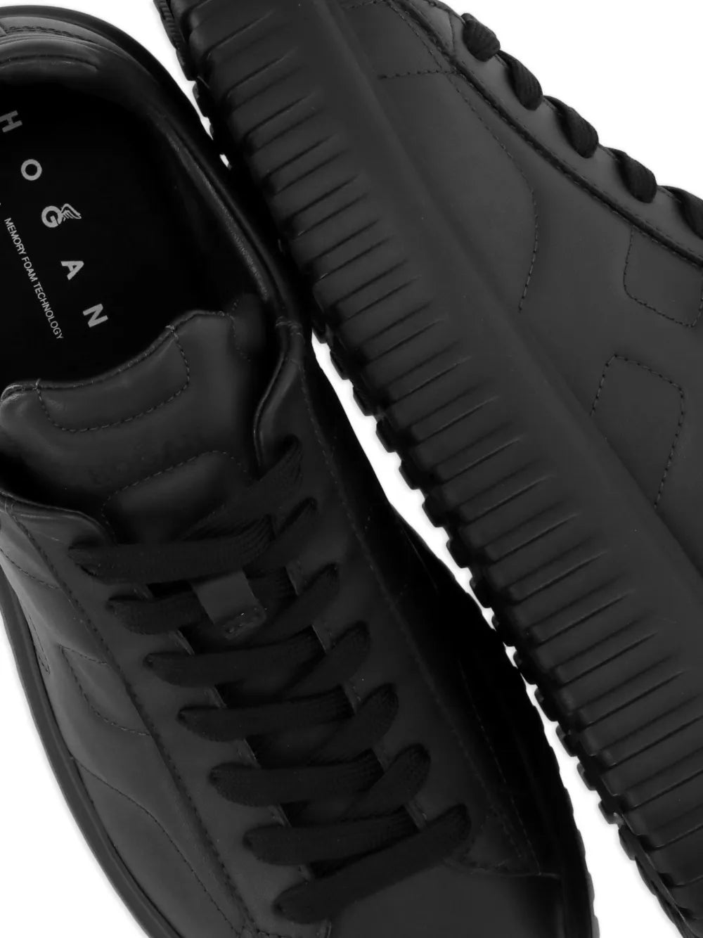 Hogan quilted black sneakers close-up of laces, padded upper and ribbed sole