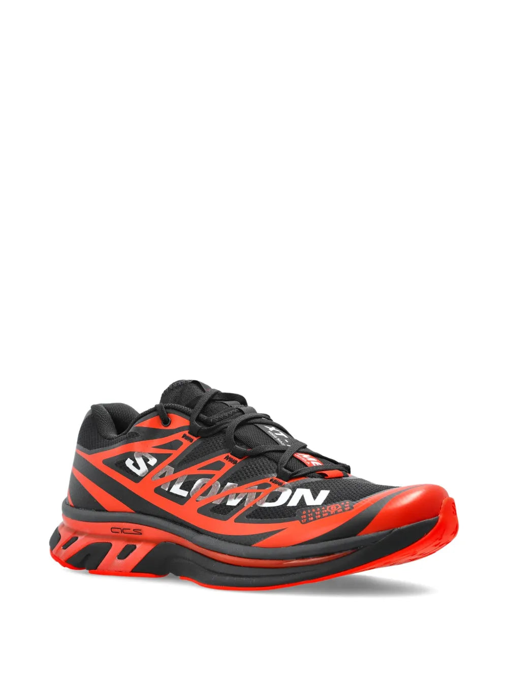 Orange and black lace-up sneakers with large logo print and chunky tread sole.