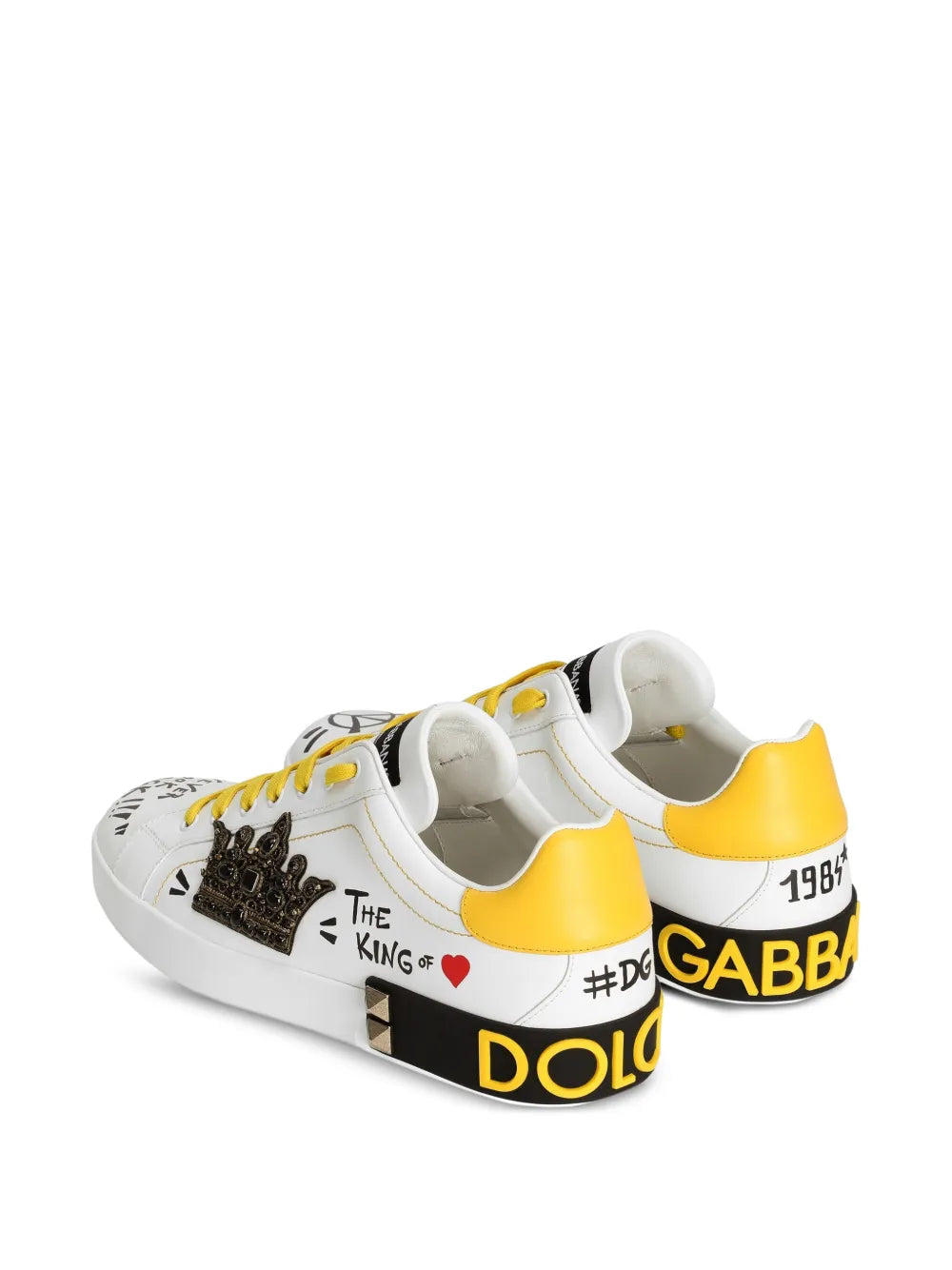 White Dolce & Gabbana sneakers, side view with studded crown and yellow heel