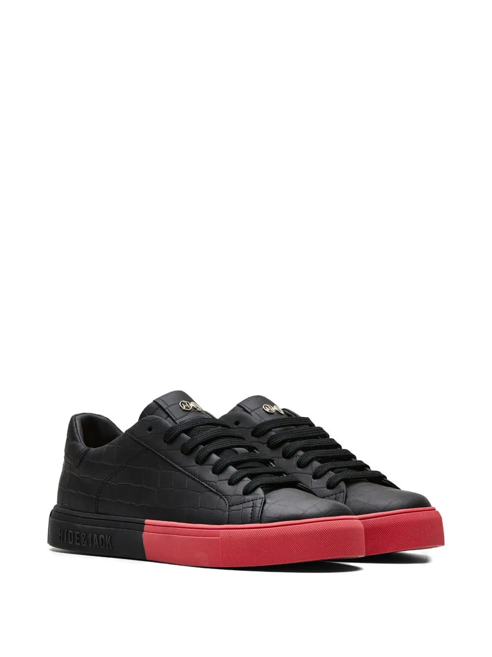 Black low-top sneakers, front three-quarter view, red outsole and textured panels