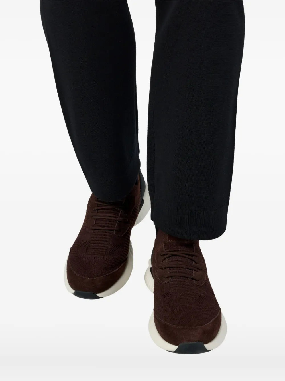 Brown Willow sneakers on feet, knit lace-up upper with white sole