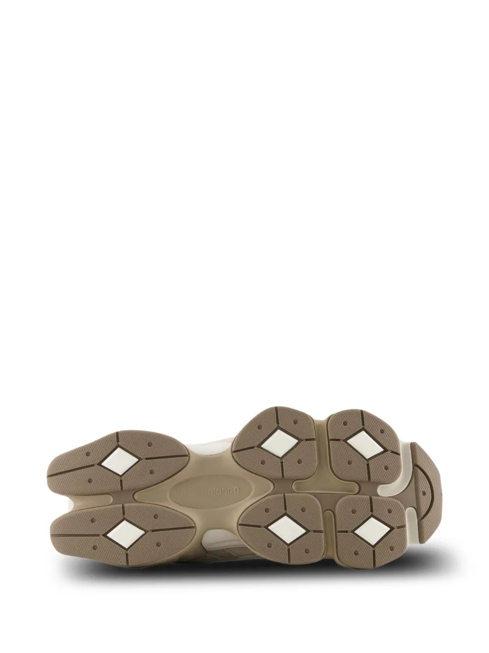Beige New Balance 9060 sneakers outsole view with multi-directional rubber tread