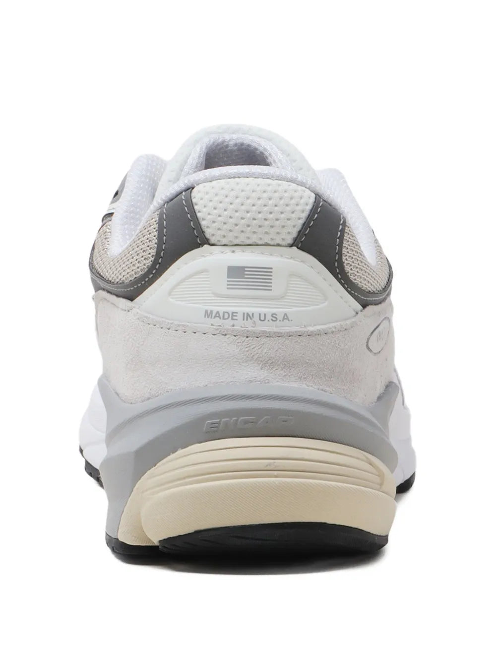 Grey and white New Balance 990V6 sneakers, heel with "MADE IN USA" label