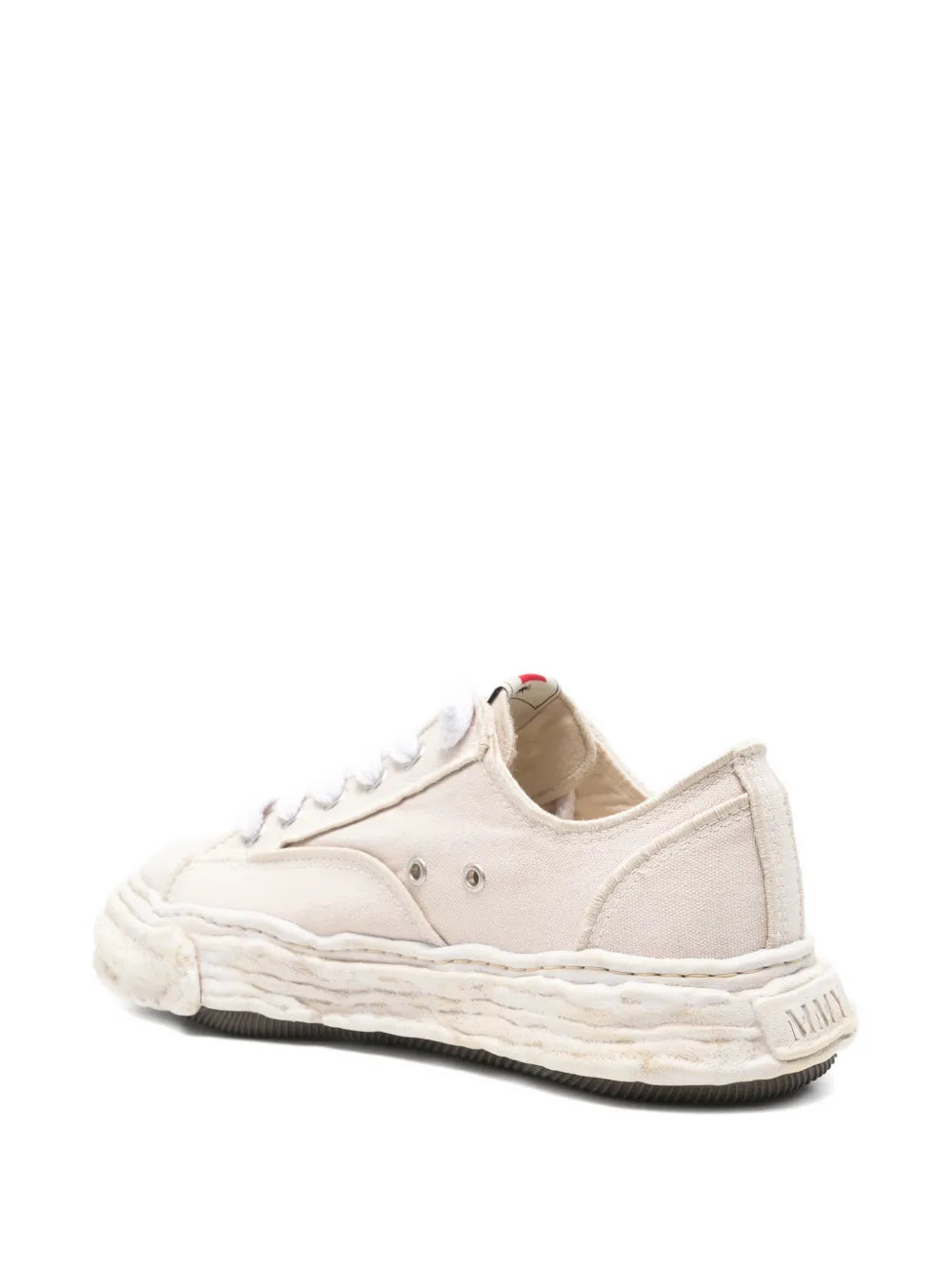 Beige distressed low-top sneakers with rear panel and white midsole stitching