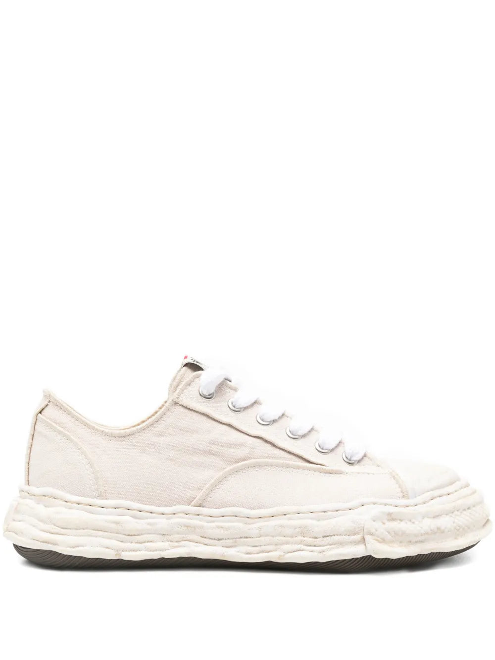Beige distressed low-top sneakers with white laces and textured rubber sole