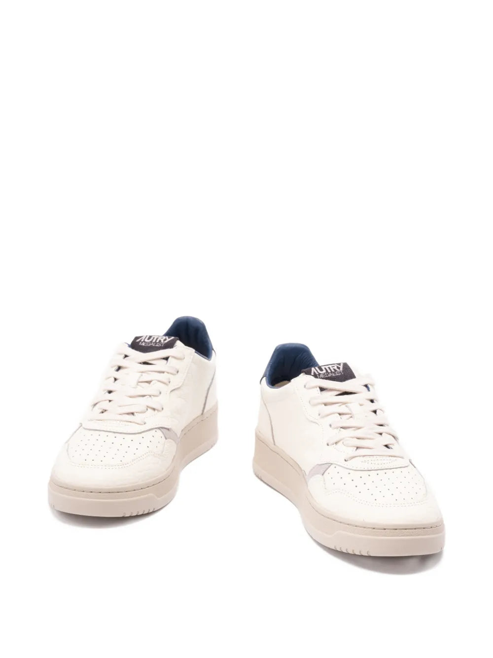 Light beige low-top sneakers with navy heel collar and lace-up front view