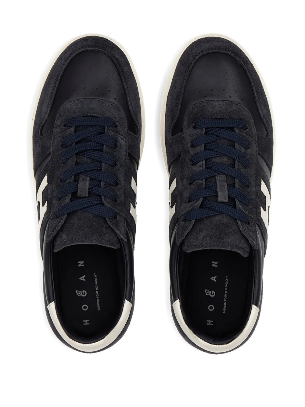 Suede sneakers with navy laces and dark interior lining, front view