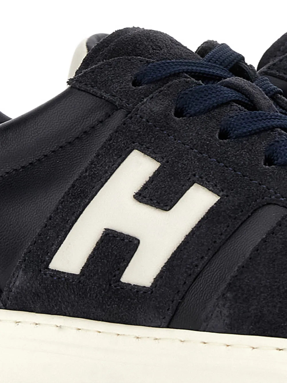 Suede side panel of Hogan H-Tv sneakers with white H logo and stitching