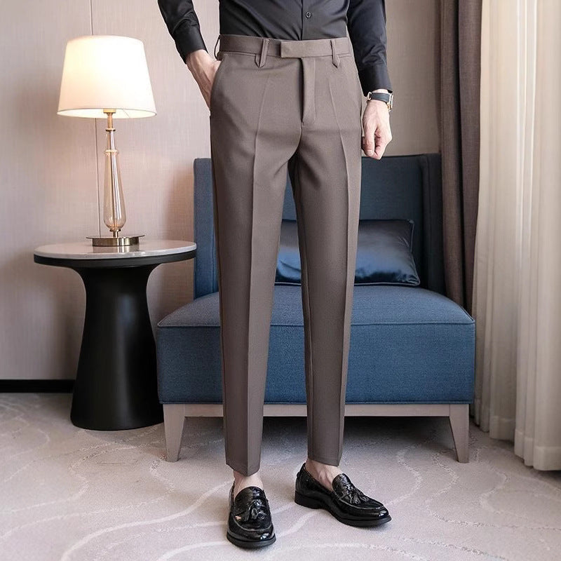 Men's dress pants in medium gray, pleat-front design with belt loops and slim legs