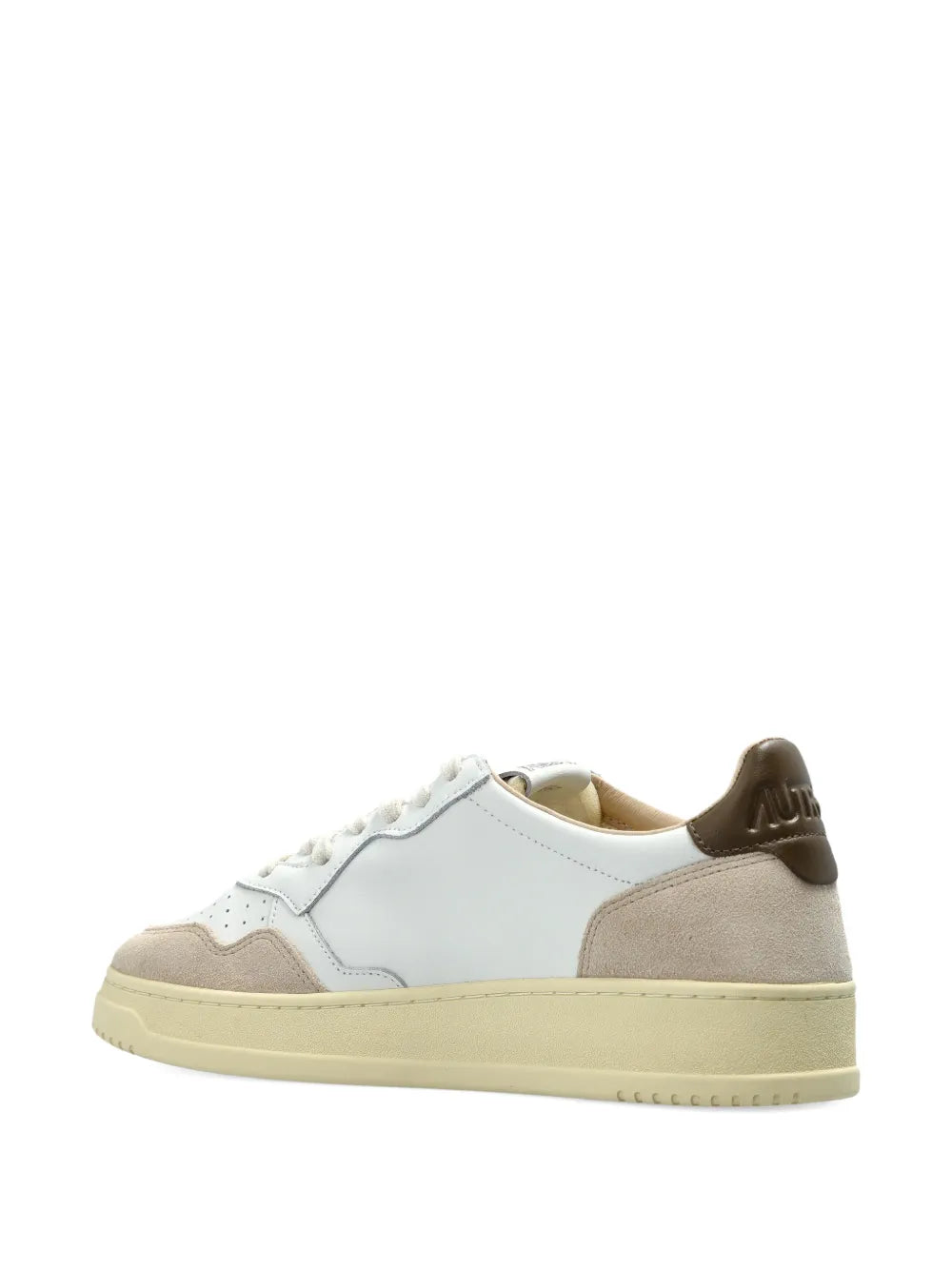 White leather low-top sneaker with beige heel tab and lace-up, gum sole.