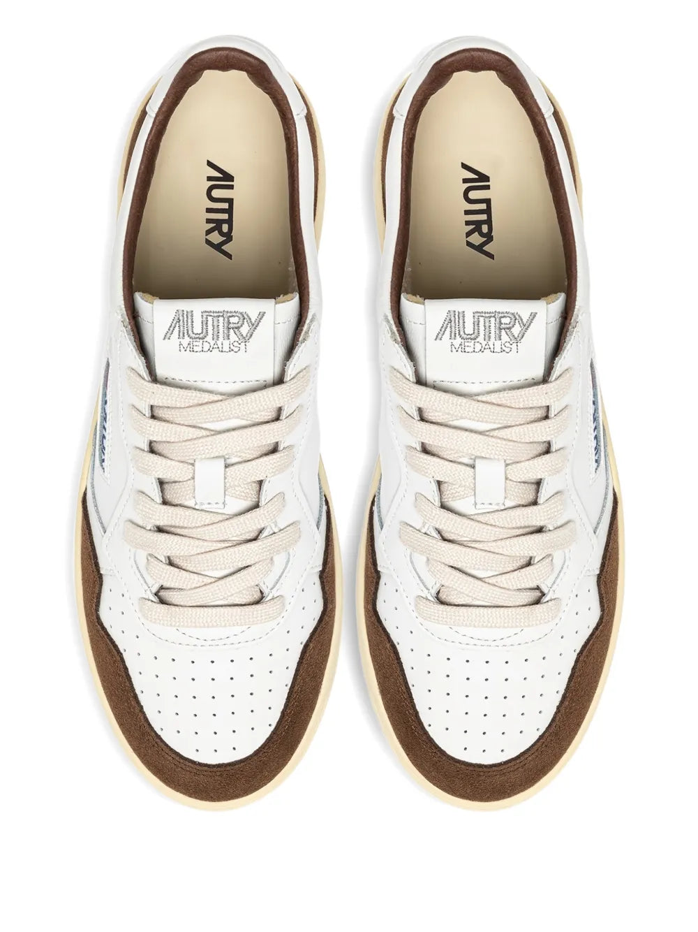 White leather sneakers with brown interior lining, lace-up eyelets and tongue branding