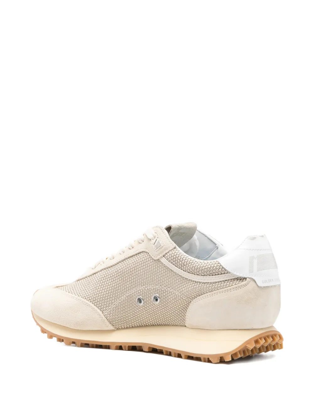 Beige low-top sneakers with mesh upper, white laces, and tan rugged rubber sole