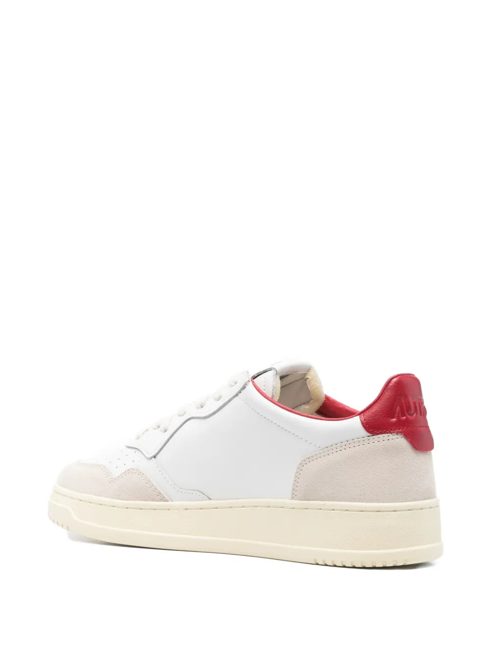 White low trainers with red heel tab and beige outsole, rear view