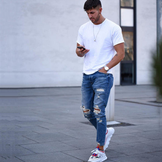 Men's deep blue ripped jeans with distressed knee patches and frayed rips
