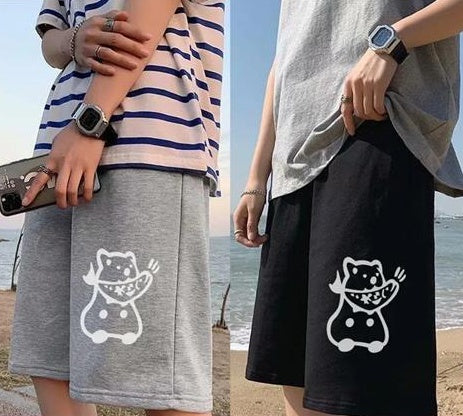 Gray straight sports shorts with white cartoon cat graphic; black shorts with cat graphic