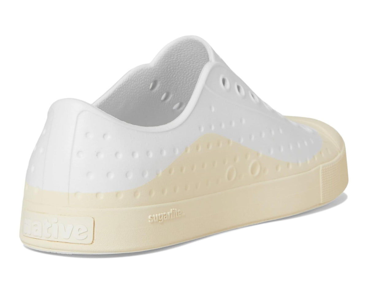 Heel and side view of white and bone slip-on sneaker with padded collar