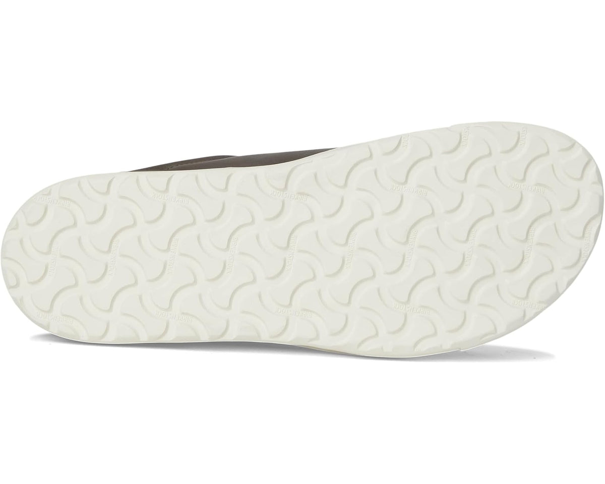 Textured tread outsole of a leather low-top sneaker