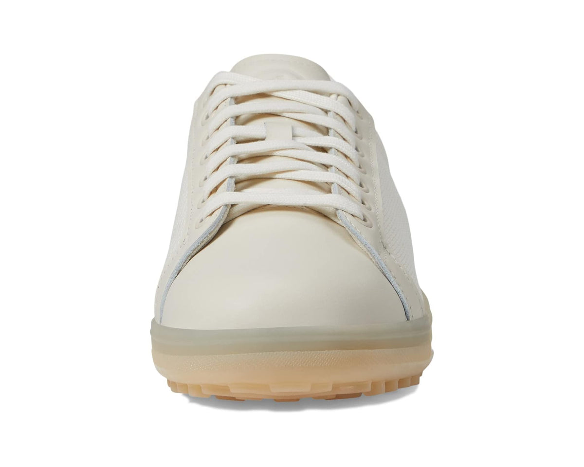 Men's adidas golf shoes toe view, lace-up chalk white with beige traction sole.