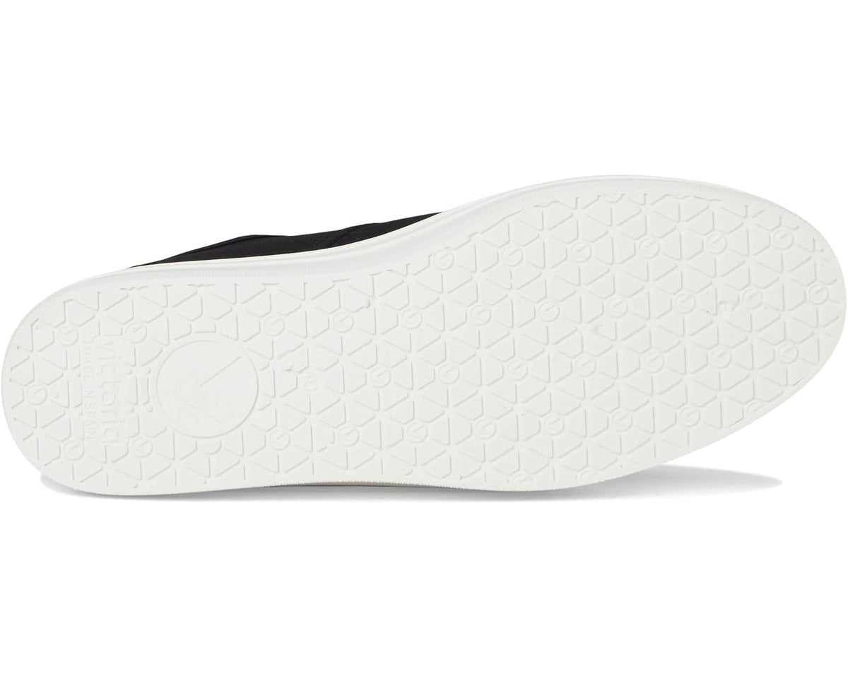 Textured white rubber outsole for black canvas low-top sneakers