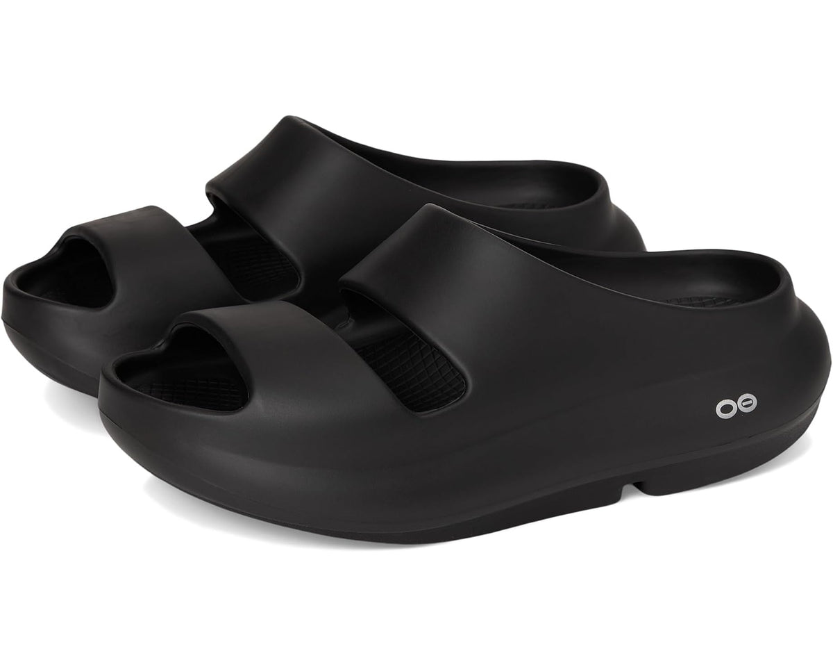 Black unisex slip-on clogs with two upper bands and oval logo on side.