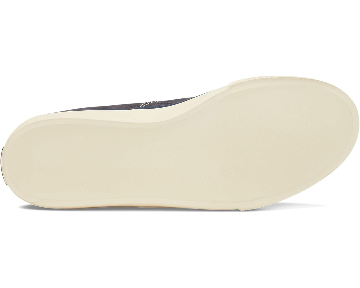 Navy canvas sneaker outsole with textured cream rubber tread