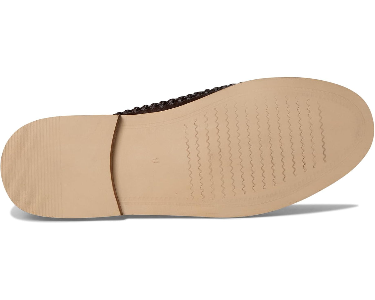 Tan outsole of dark brown leather moc-toe loafer with textured traction tread