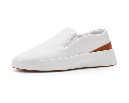 White slip-on sneakers with stitched upper and brown rubber platform sole
