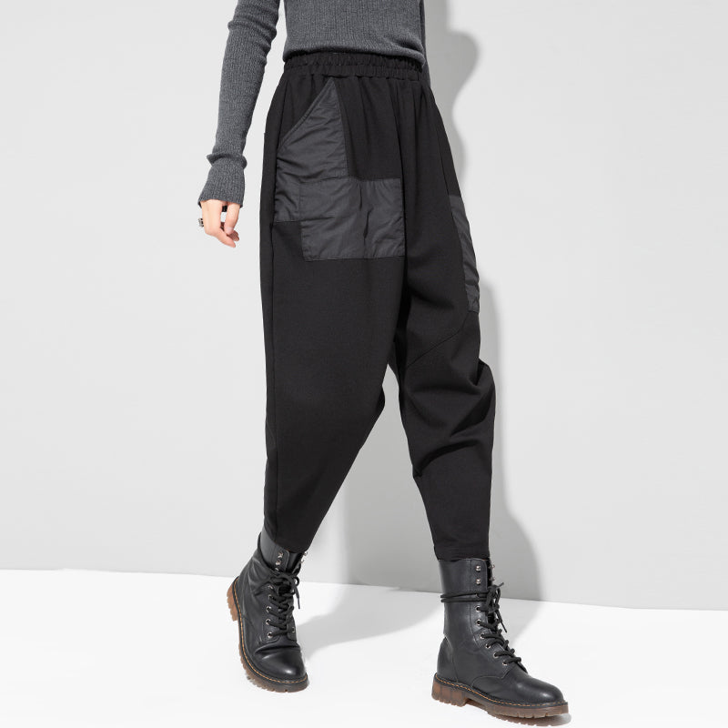 Black cropped loose pants back view with elastic waist and large patch pocket panels