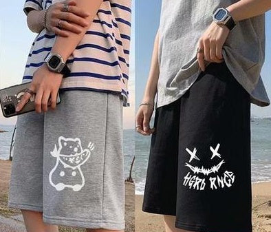 Gray shorts with white cartoon cat graphic; black shorts with white skull crossbones print