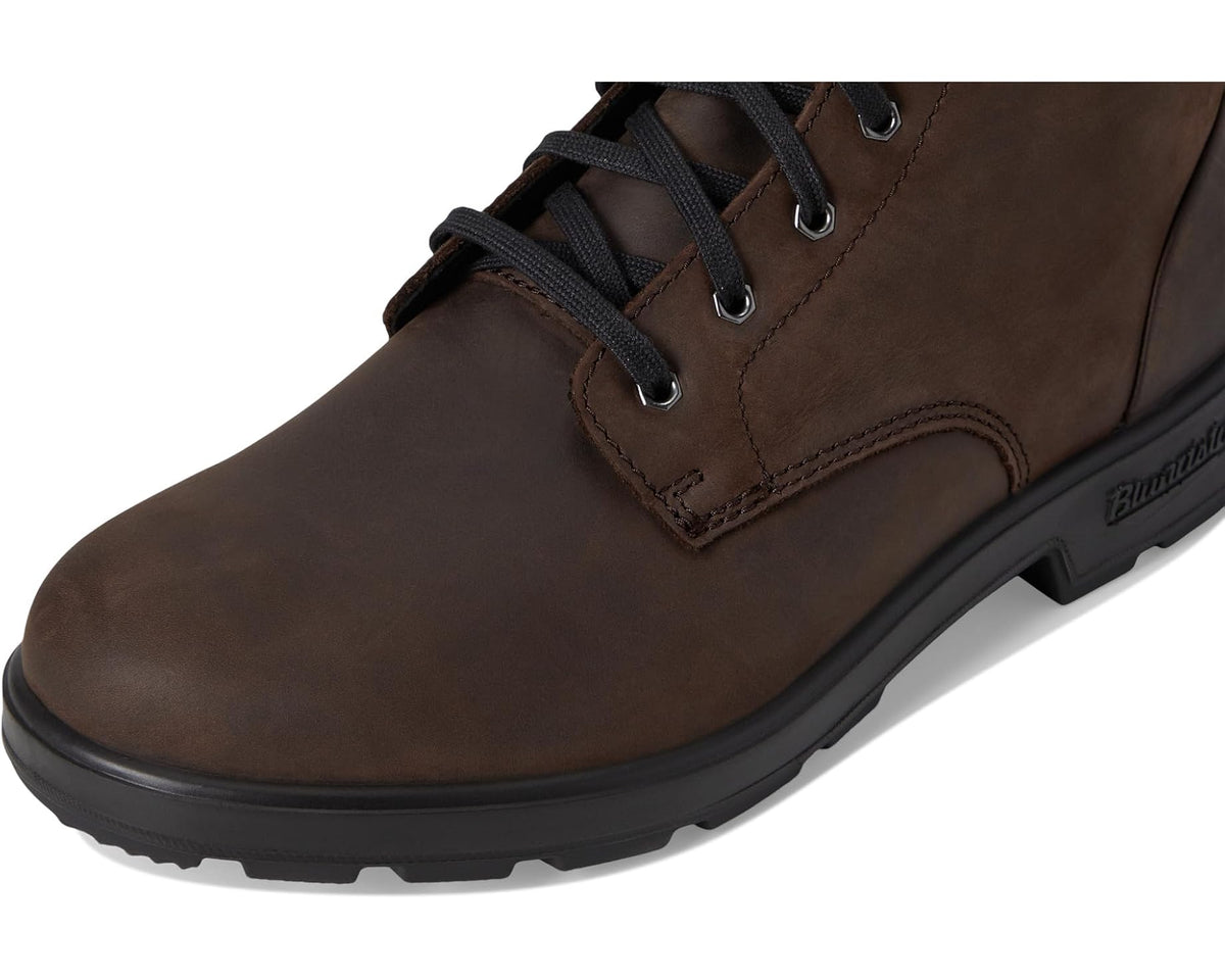 Unisex Blundstone brown suede boots, front quarter close-up with stitched panel and laces