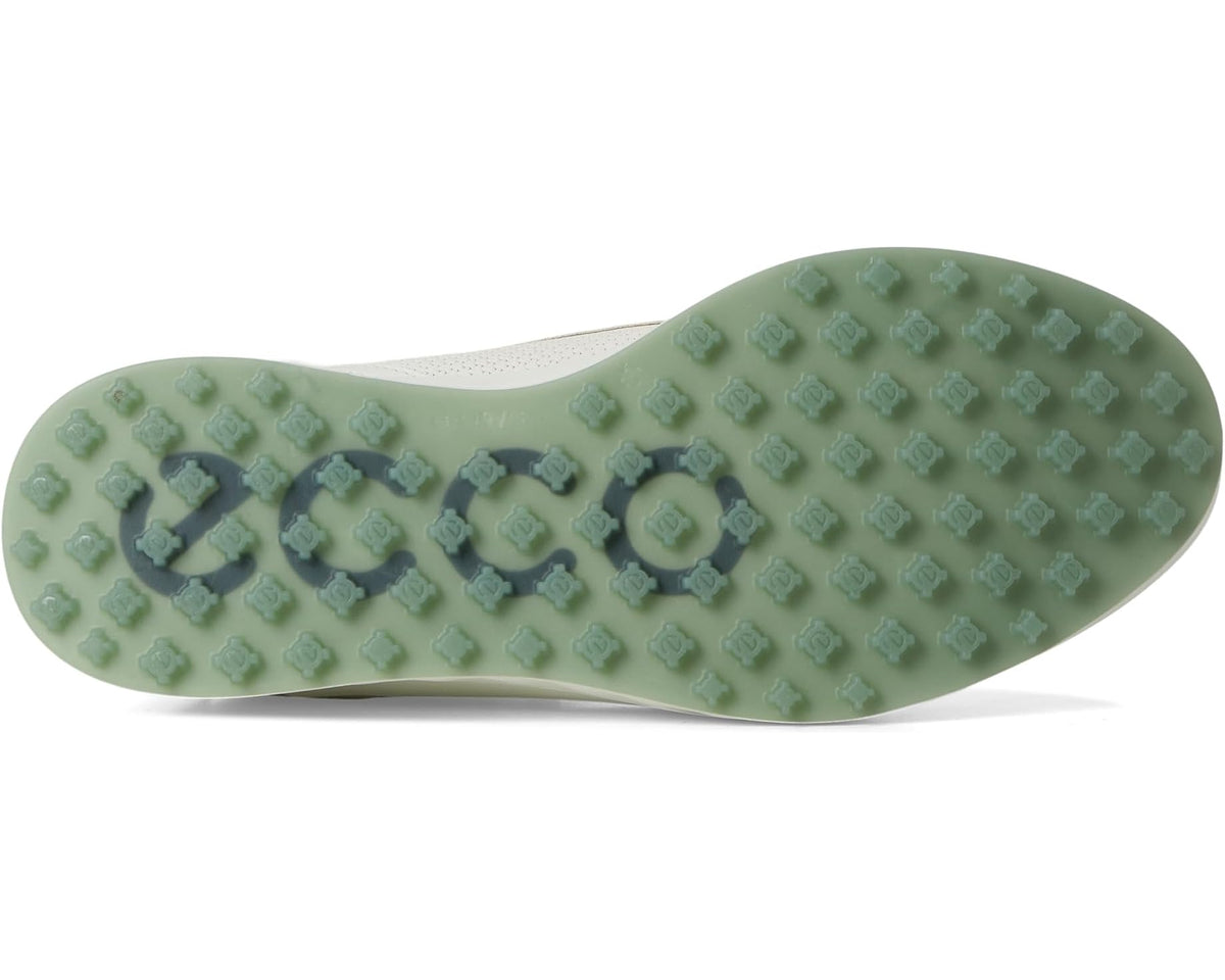White golf shoe outsole with green traction studs