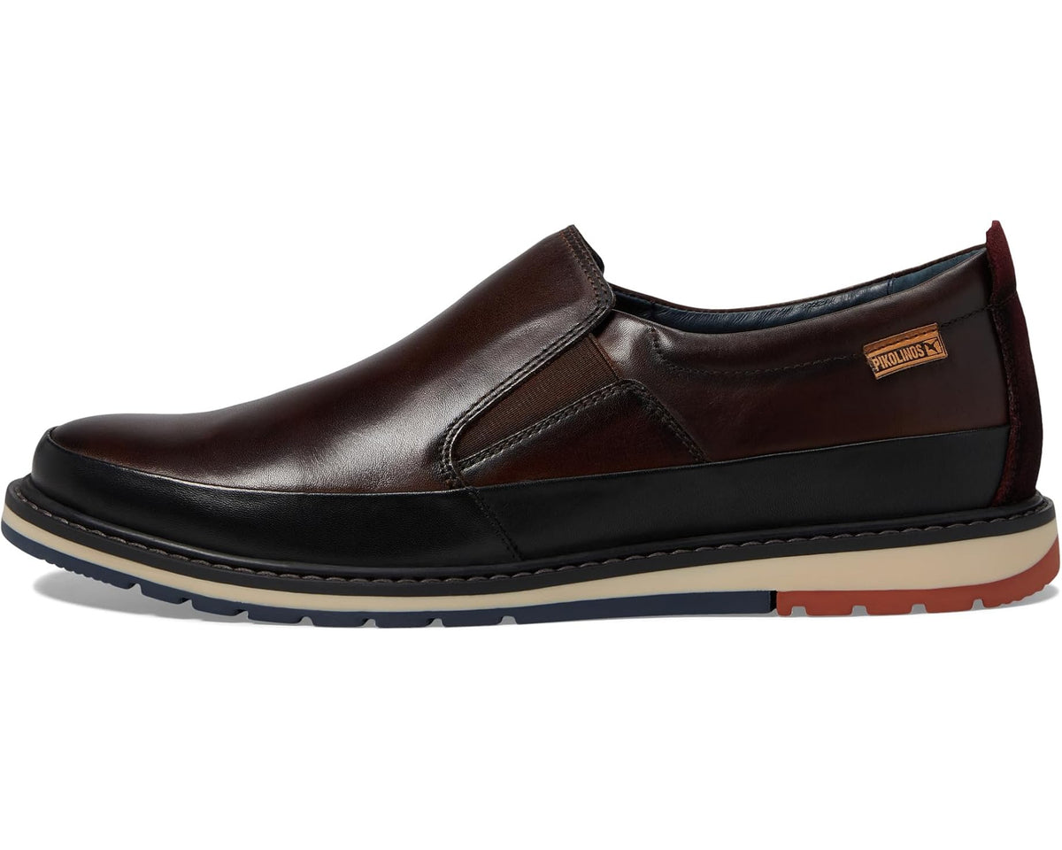 Men's brown leather slip-on shoes with stitched panels and small brand tag