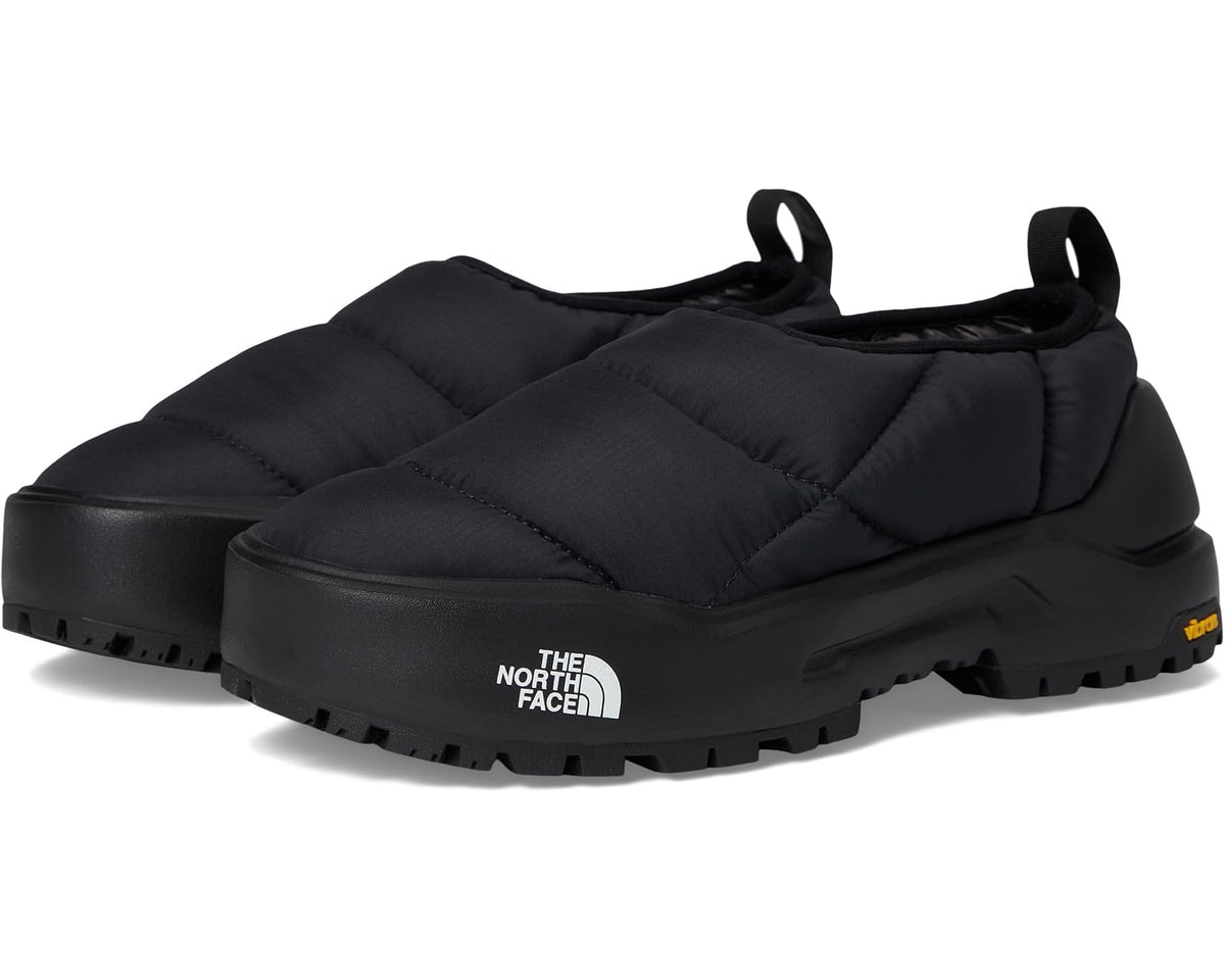 Black insulated slip-on mule shoes with quilted ThermoBall-style padding and logo