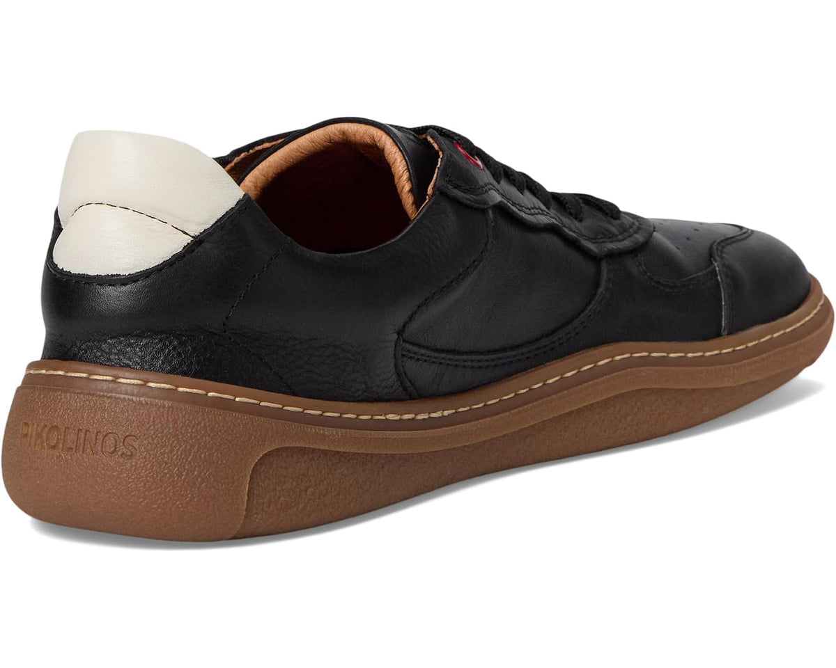 Black unisex sneakers with white heel lining and tan rubber outsole