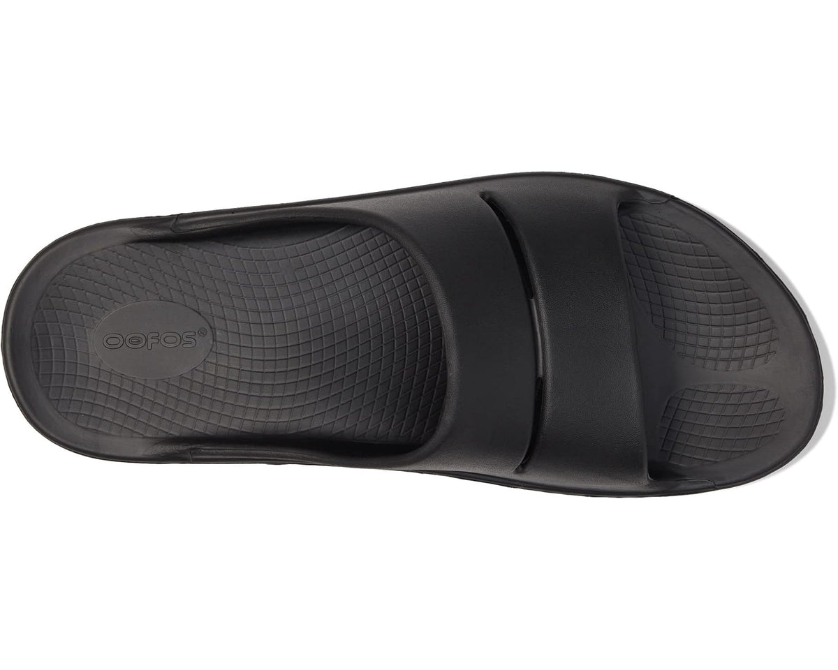 Black OOahh slide sandal interior with textured footbed and OOFOS logo