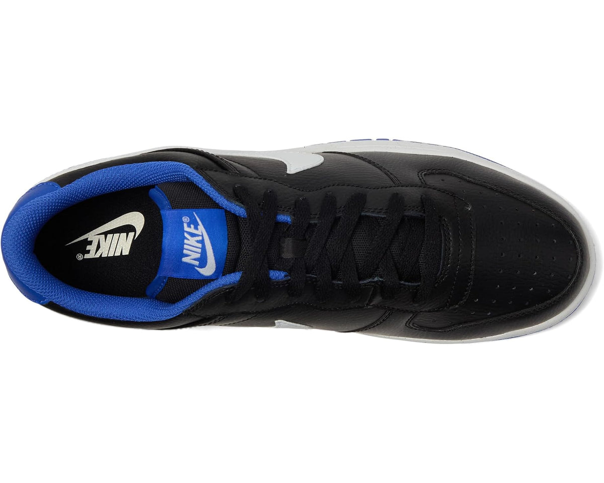 Nike low-top sneakers, side view: black leather upper with blue lining and lace-up.