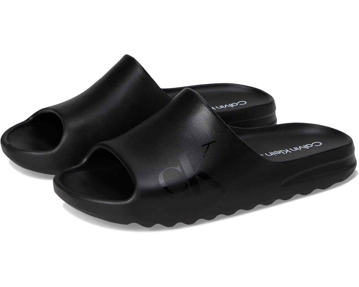 Black Calvin Klein slide sandals with open toe and cushioned footbed
