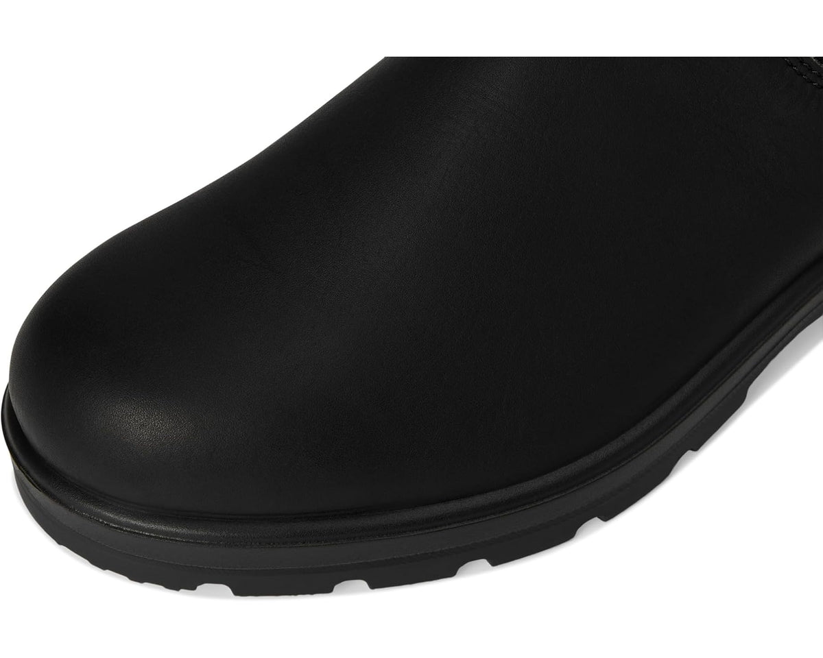 Black leather Chelsea boot toe and sole with treaded rubber outsole