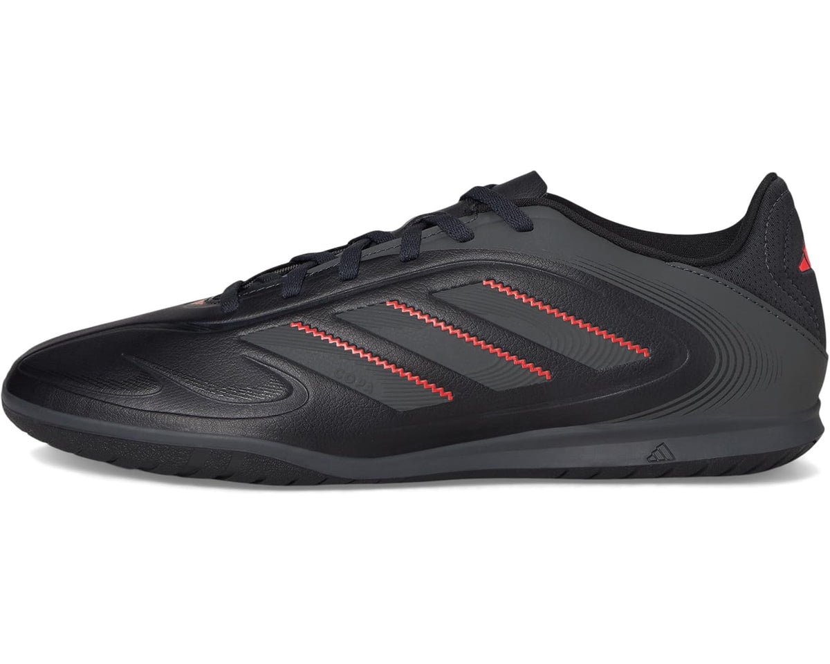 Black adidas indoor soccer shoes with red stripe detailing, lace-up low profile